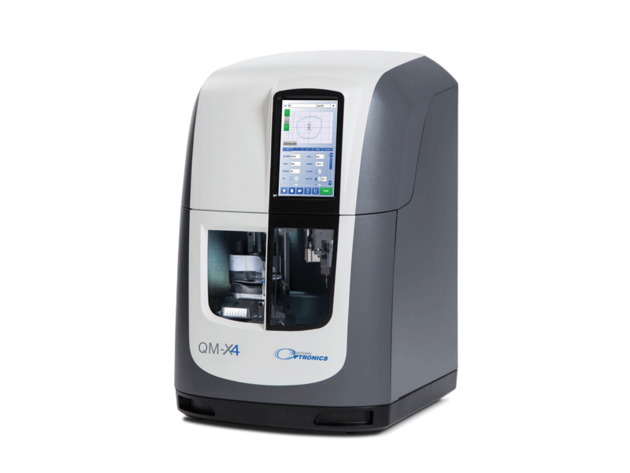 Compact optical lens processing machine with touchscreen control panel.