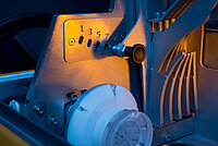 Close-up of a machine component with gear mechanism and plastic part in the manufacturing process