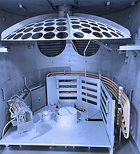 Interior of semiconductor processing chamber with circular wafer holder and multiple slots for wafers.