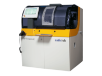 Automated industrial machine with enclosed housing and side control monitor for precise manufacturing processes