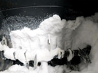 Interior of a container coated with frost and ice buildup.