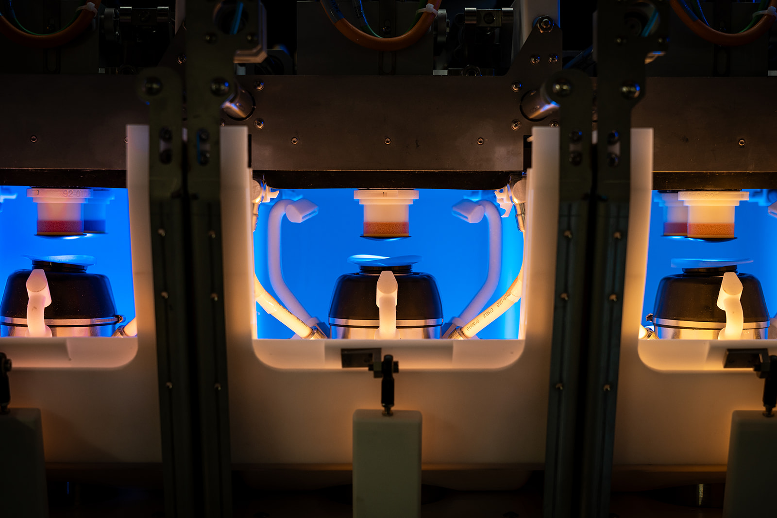 Satisloh NEO-Flex lens processing machine shown in a production environment, designed for high-precision surfacing and polishing of ophthalmic lenses.